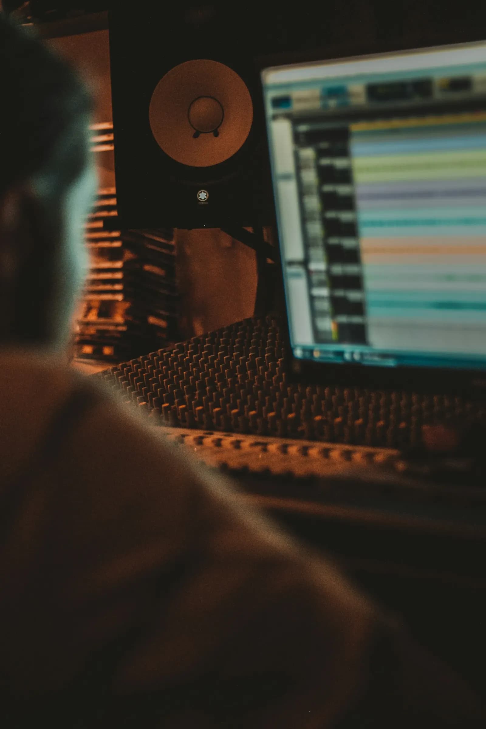 Music designer working at a mixing desk in the studio